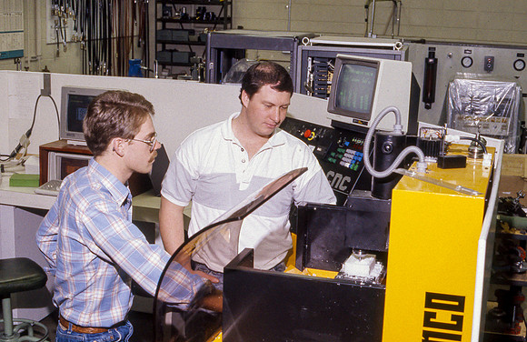 Student works alongside teacher in Manufacturing Technology. January 1990.