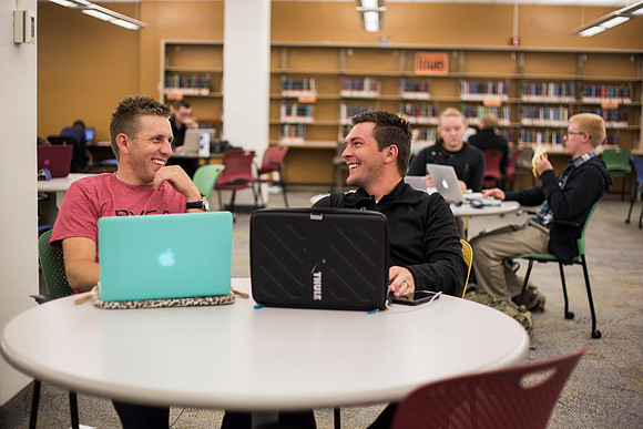 Students prepare for their classes, in the McKay Library.