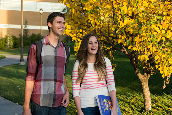 Students walk outside the Ricks building, enjoying the beautiful weather.