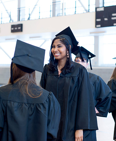 Graduates wait inside the gym area preparing to enter Commencement ceremony. Photo by Leanna Davidson