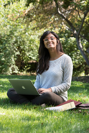 Student Noor Sofi poses in the Gardens for online learning.