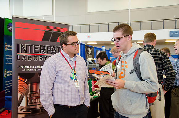 BYU-Idaho students speak to representatives from colleges or companies from their field of study at a career fair held in the I-Center gym