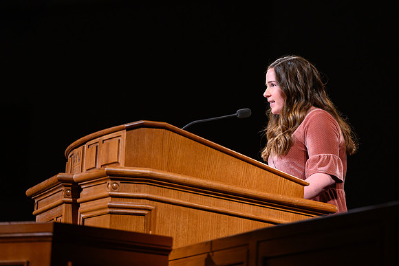 A student speaks during devotional, held in the BYU-Idaho Center.