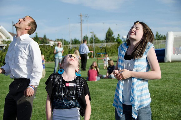 Online instructors gather with their families for an eveing of BBQ and games.