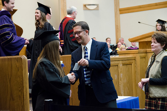 Student Graduates at the College of Education and Human Development Convocation in the HInckley Chapel.