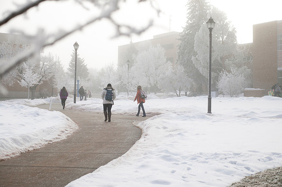 Students walk to class on a foggy, winter morning on campus