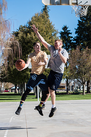 Jacob and Jacob, two BYU-Idaho students, play one on one basketball at the Smith Park court.