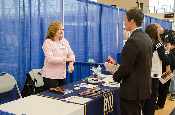 BYU-Idaho students speak to representatives from colleges or companies from their field of study at a career fair held in the I-Center gym