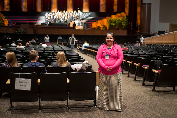 An usher stands ready to help as students begin to gather for devotional.