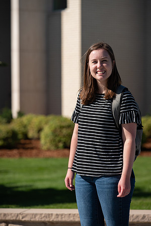 Examples of students staying safe and healthy during the COVID-19 pandemic by social distancing, following pathway arrows, and wearing face masks.
