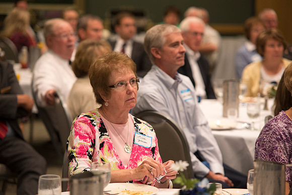 Alumni of the class of 1964 and earlier gather and honor the Briggs for their service.