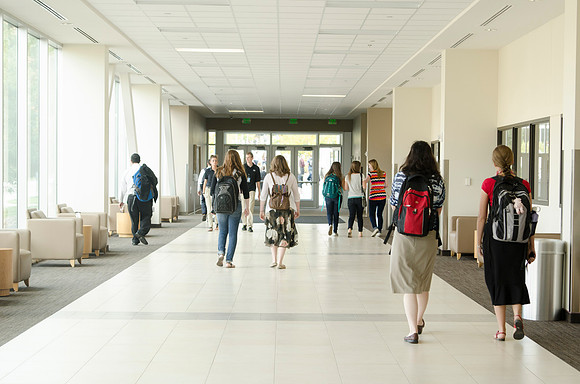 Students walking out on campus after devotional