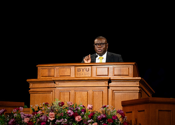 Elder Egbo speaking to students in the BYUI Center.