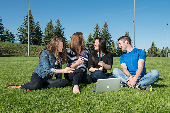 Student models interact and smile for marketing purposes that will be used for the new Campus Housing next to The Ivy.