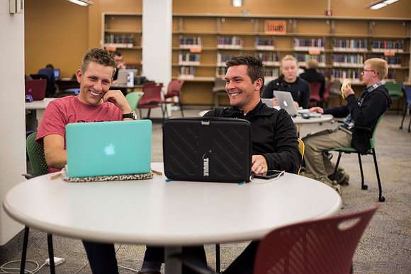 Students prepare for their classes, in the McKay Library.