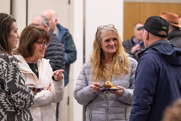 Employees gather for the annual Christmas gathering with President and Sister Meredith.