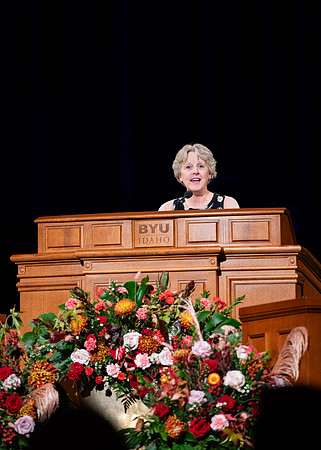 Elder and Sister Boom speak at devotional in the BYUI Center.