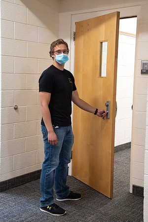 Examples of students staying safe and healthy during the COVID-19 pandemic by social distancing, following pathway arrows, and wearing face masks.