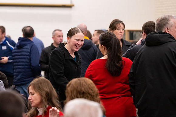 Employees gather for the annual Christmas gathering with President and Sister Meredith.