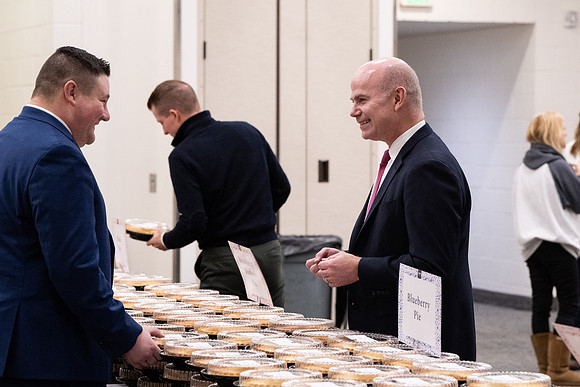 Employees gather for the annual Christmas gathering with President and Sister Meredith.