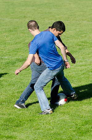 A group of students play a friendly game of soccer.