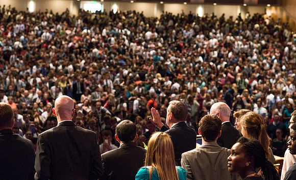Elder Jeffrey R. Holland waves goodbye at the end of devotional.