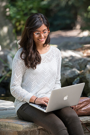 Student Noor Sofi poses in the Gardens for online learning.