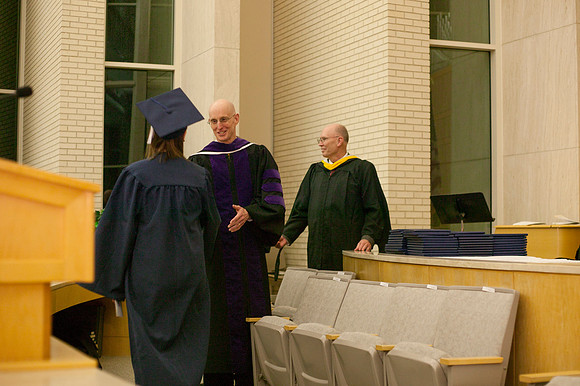 Advancement Vice President Henry J. Eyring congratulates students in the Taylor Chapel.
