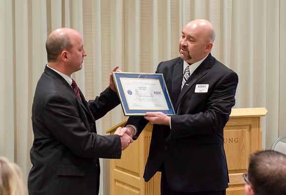 Todd Smith receiving an award on behalf of BYU-Idaho from the Office of the Secretary of Defense for the support BYU-Idaho has given to Peter Stilling while he has been serving in the Guard. Awarded b