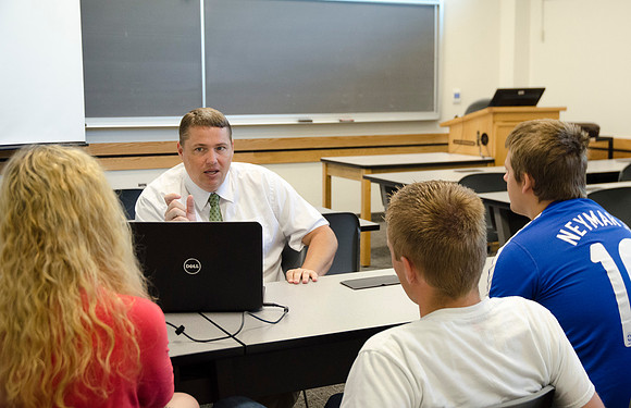 Matt Miles helps students work on group project.