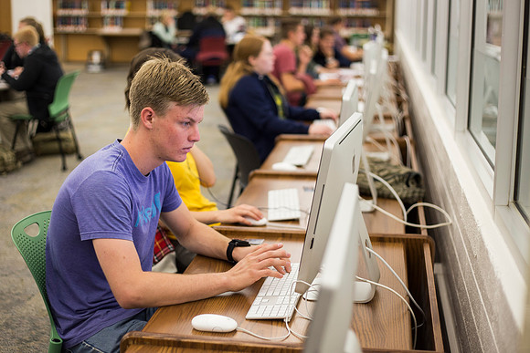Students prepare for their classes, in the McKay Library.