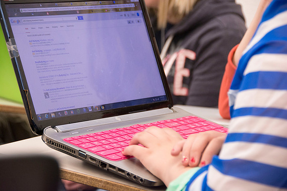 In order to work on her group project, a student looks articles on Google that will help them during the 2014 Spring Semester.