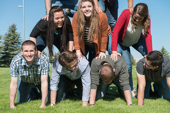 Student models interact and smile for marketing purposes that will be used for the new Campus Housing next to The Ivy.