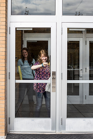 Student employees clean the library windows.