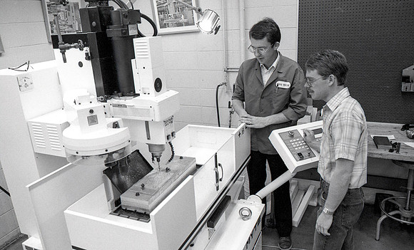 Student works alongside teacher in Manufacturing Technology. December 1990.
