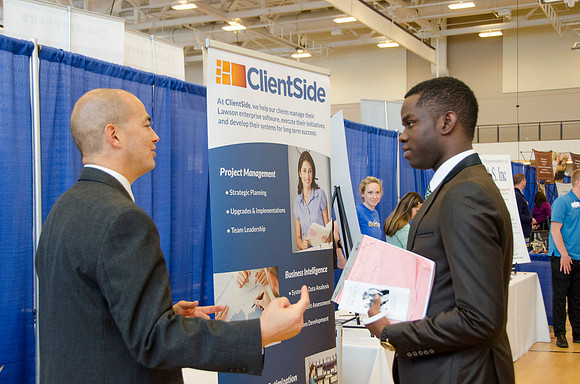 BYU-Idaho students speak to representatives from colleges or companies from their field of study at a career fair held in the I-Center gym
