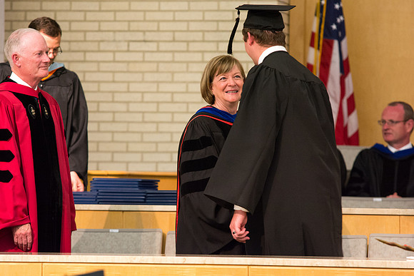 Graduate of the College of Physical Sciences and Engineering being congratualted by President Kim B Clark and Young Womens General President, Bonnie L. Oscarson at the convocation ceremony held in the