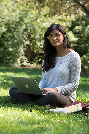 Student Noor Sofi poses in the Gardens for online learning.