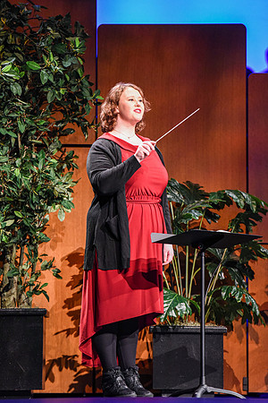 A student leads the congrgation in singing a hymn.