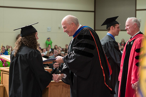 Elder Maynes and Pres Clark congratulate the graduates in the College of Language and Letters Convocation in the Manwaring Center Ballroom.