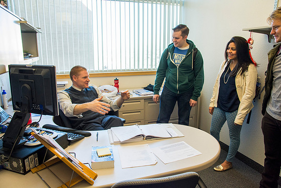 Jeremy Lamoreaux, faculty member of the Brigham Young University-Idaho Political Science department, with students in his office.