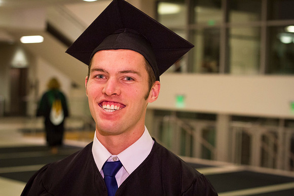 Michael Warr smiles after commencement in the I-Center.