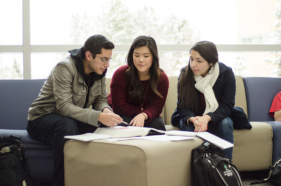A group of students interact in the Ricks.