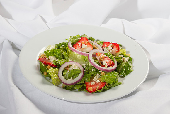 Fresh mixed Salad Greens topped with Strawberries, Blue Cheese, Red Onions and toasted Walnuts. Served with Honey Poppy Seed Viniagrette.