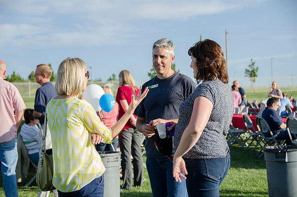 Online instructors gather with their families for an eveing of BBQ and games.