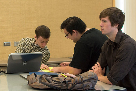 Design students go over their projects in Identity Design with instructor Scott Franson. These projects cover the use of logos and images in businesses.
