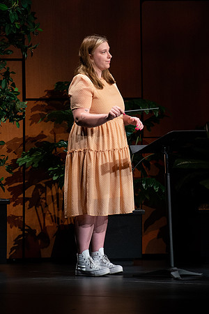 BYU-I student conducting a hymn during devotional.
