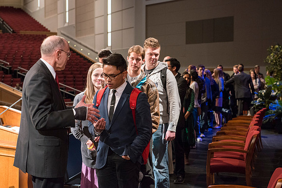 Russel T. Osguthorpe, the president of the the General sunday School, greets students and employees after devotional.