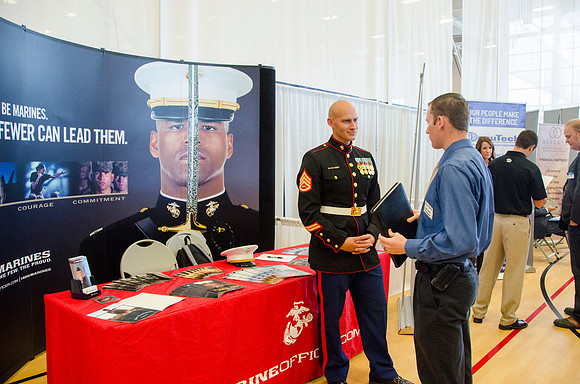 BYU-Idaho students speak to representatives from colleges or companies from their field of study at a career fair held in the I-Center gym