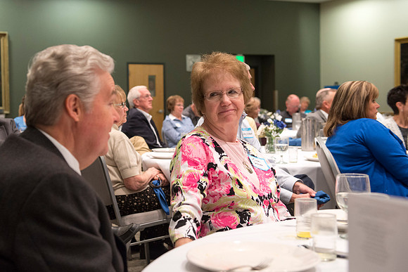 Alumni of the class of 1964 and earlier gather and honor Kay and Cheryl Briggs with the Alumni Award of Excellence for their service.